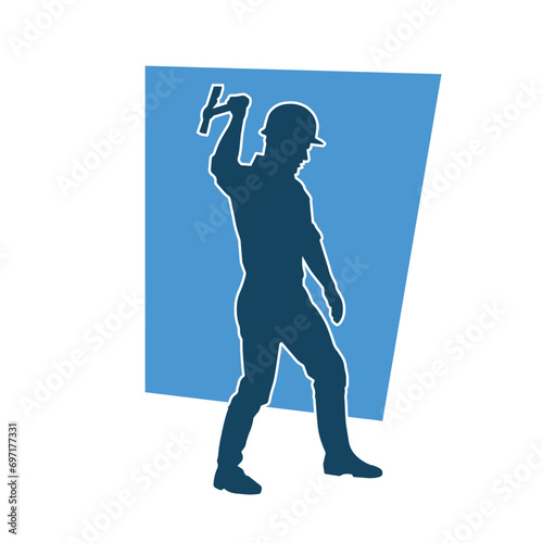 Silhouette of a worker in action pose using his axe tool.