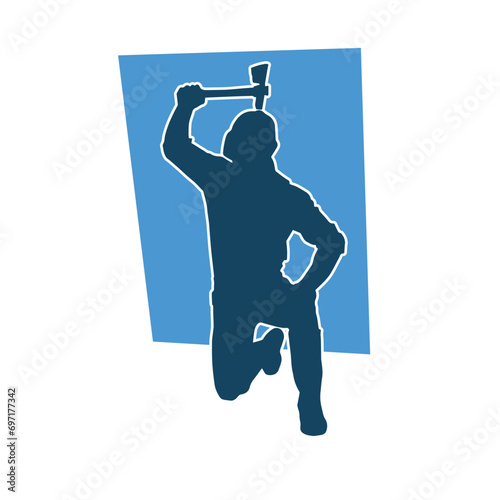 Silhouette of a worker in action pose using his axe tool.