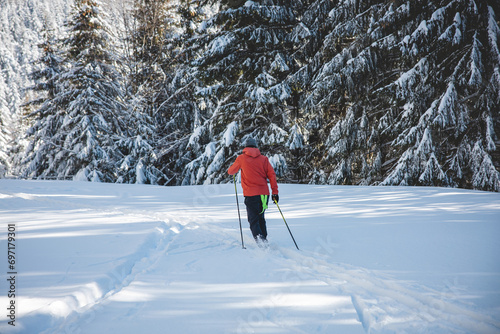 Young adult cross-country skier aged 20-25 making his own track in deep snow in the wilderness during morning sunny weather in Beskydy mountains, Czech Republic © Fauren