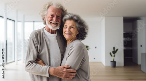 Two people, senior married couple in their empty new apartment 