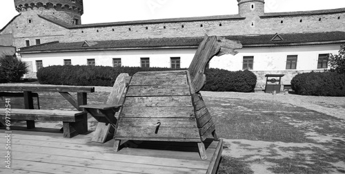 Kamyanets-Podilsky citadel tourism museum, Ukraine. 12 may 2023.  Old wooden horse for punishment in the courtyard of the castle