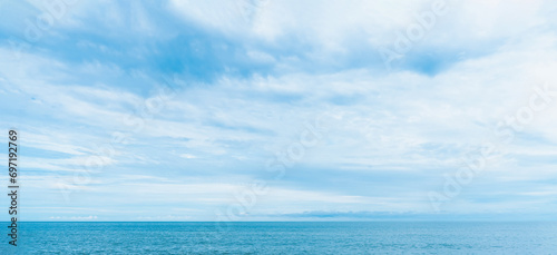 Sky Blue,Cloud Background,Horizon Clear Spring Sky in Morning by the beach,Beautiful landscape nature sunrise in Summer,Backdrop Banner panoramic banner white clouds over ocean blue © Anchalee