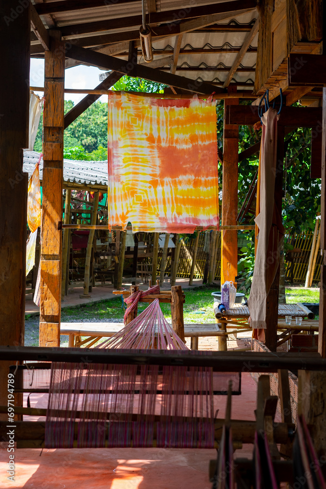 Natural color dye t-shirt hanging on plastic rope at the garden, outdoor day light, natural color dyeing workshop in Thailand