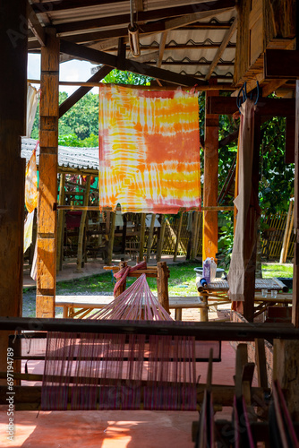 Natural color dye t-shirt hanging on plastic rope at the garden, outdoor day light, natural color dyeing workshop in Thailand © tarfullhd