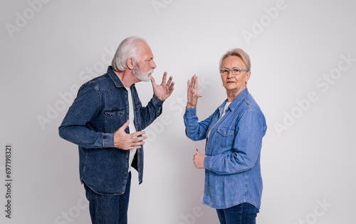 Canvas-taulu Senior woman showing stop gesture to frustrated husband while having argument on
