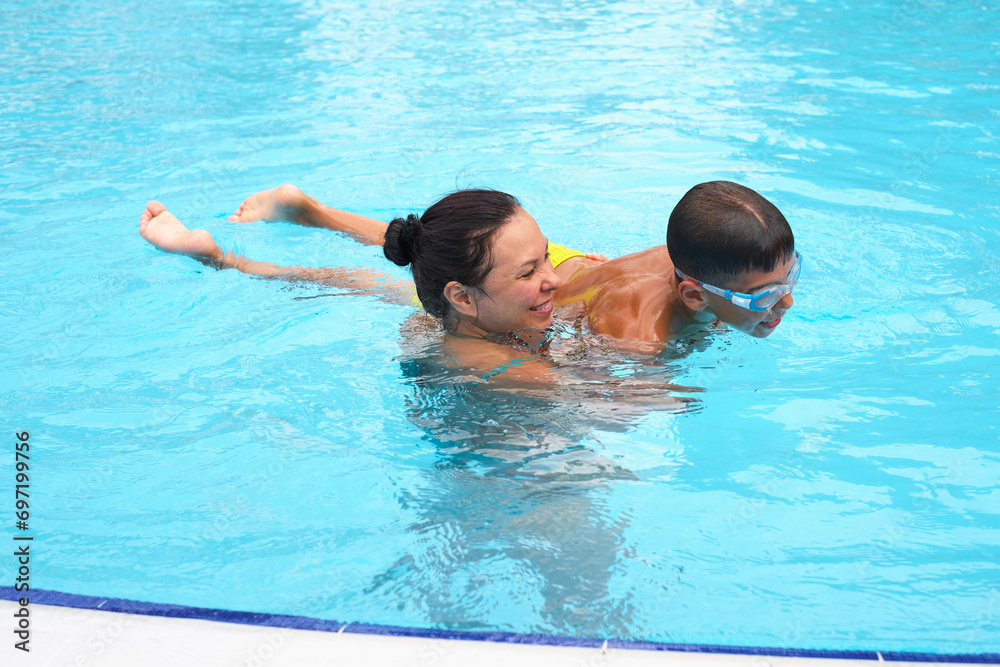 A poolside holiday moment; mother and son's delight. Represents the shift to wellness and joy in family travels.