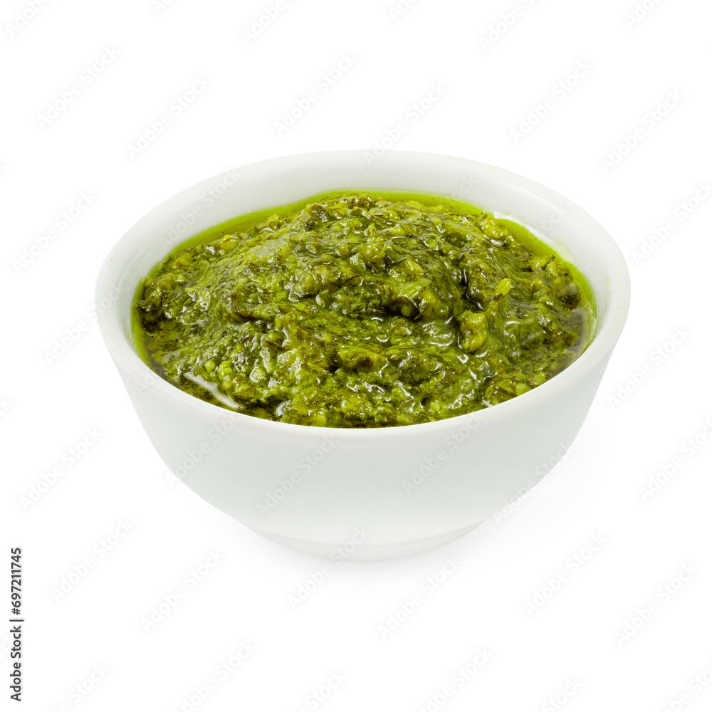 Pesto sauce, on a wooden board, on a white background Pesto sauce, on a wooden board, on a white background