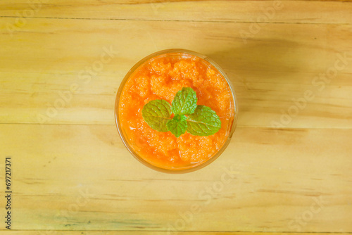 Carrot smoothie, healthy drink in glass, top view