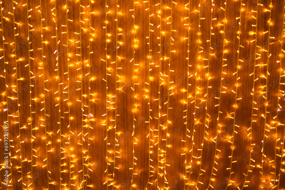 Wedding or Christmas lights on warm background. Glowing light bulb garland. Copy space and empty place for advertising text Wedding or Christmas lights on warm background. Glowing light bulb garland. Copy space and empty place for advertising text