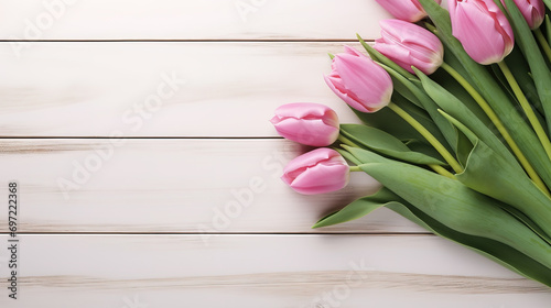 Bouquet of tulips on wooden background. Top view with copy space  