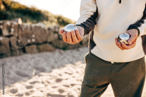 Midsection of senior man holding Petanque balls in hand photo