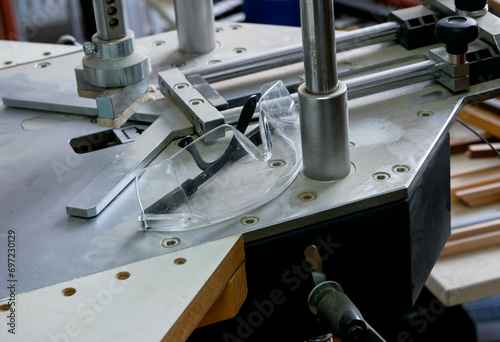 Plastic safety glass on underpinner in a small glass working shop. photo