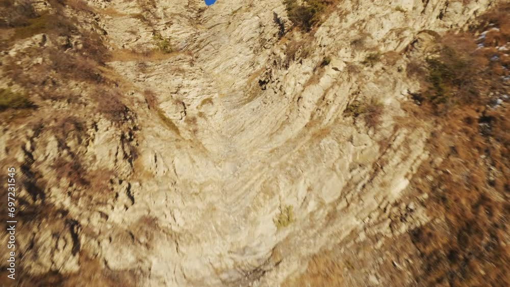 FPV drone flight over snowy Alpine peaks and ravines at sunset. Winter magic in every twist and turn. FPV drone flight over snowy Alpine peaks and ravines at sunset. Winter magic in every twist and turn.