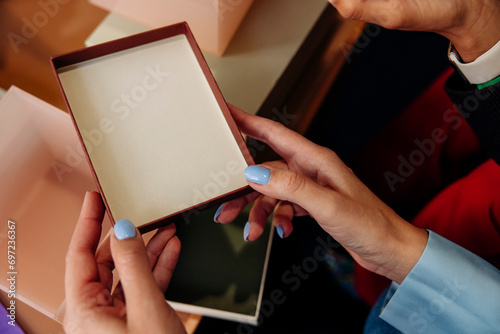 High angle view of businesswoman holding box lid at office photo
