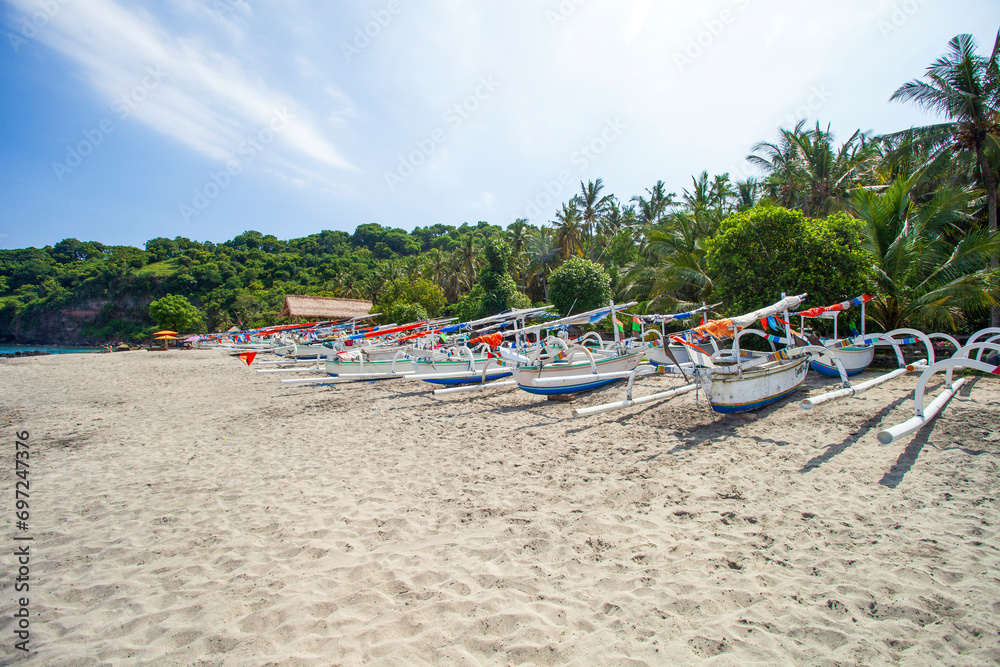 Virgin beach or White Sand beach in Bali, Indonesia with wooden fishing boats on the sand Virgin beach or White Sand beach in Bali, Indonesia with wooden fishing boats on the sand