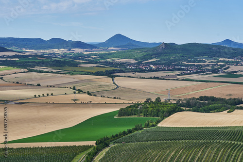 Landscape picture of the cultural country of Central Bohemian Uplands a geomorphological region in northern Bohemia of Czech Republic with intensive agricultural crop production and apple orchards. photo