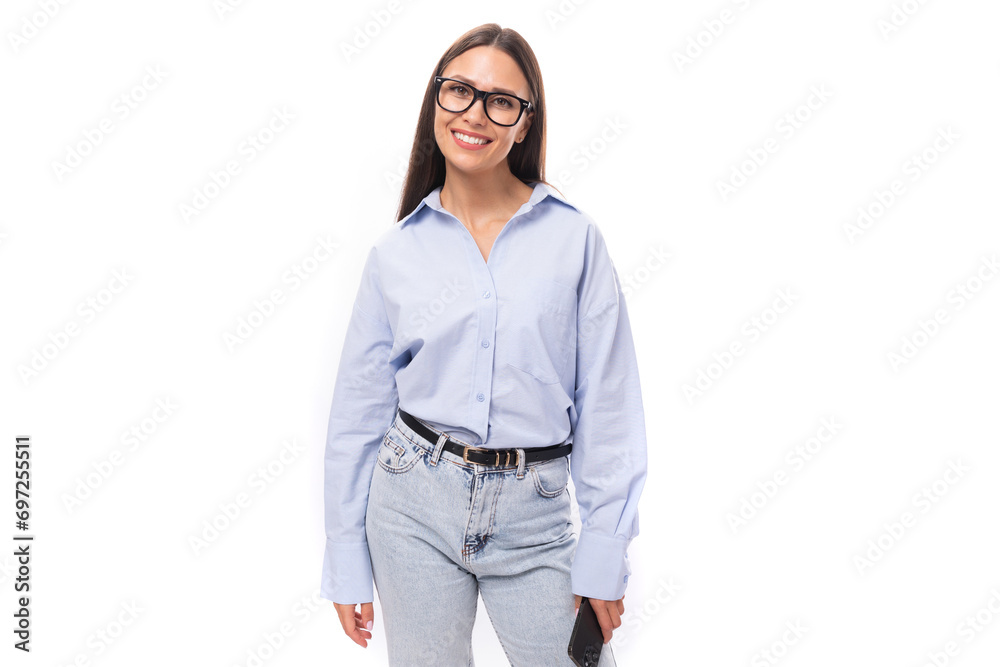 young pretty european business woman with long black hair dressed in a blue blouse and glasses on a white background with copy space young pretty european business woman with long black hair dressed in a blue blouse and glasses on a white background with copy space