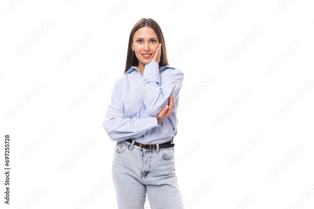 portrait of a stylish well-groomed young brunette caucasian woman with straight hair dressed in a sky blue blouse on a white background with copy space portrait of a stylish well-groomed young brunette caucasian woman with straight hair dressed in a sky blue blouse on a white background with copy space