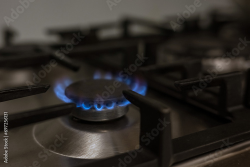 Gas burner on kitchen stove for cooking with fire, energy concept