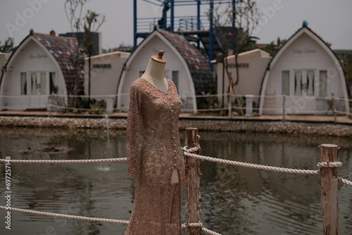 Asian Wedding dress kebaya payet Sundanese Culture with village and lake as a background