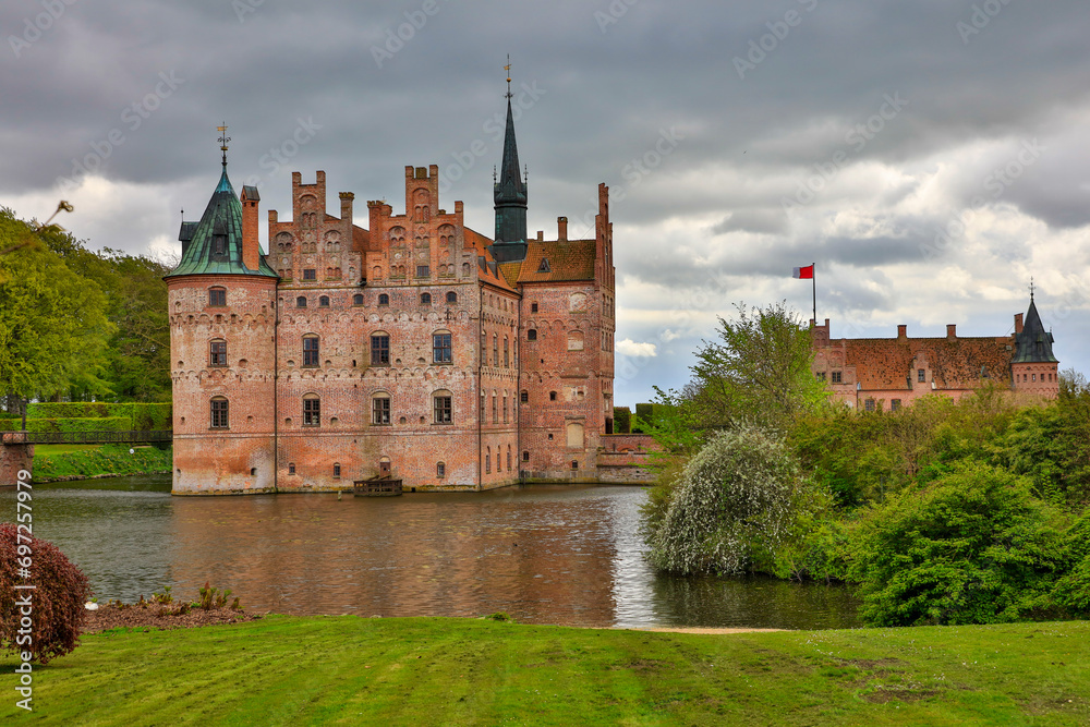 Denmark Egeskov Castle view on a cloudy spring day Denmark Egeskov Castle view on a cloudy spring day