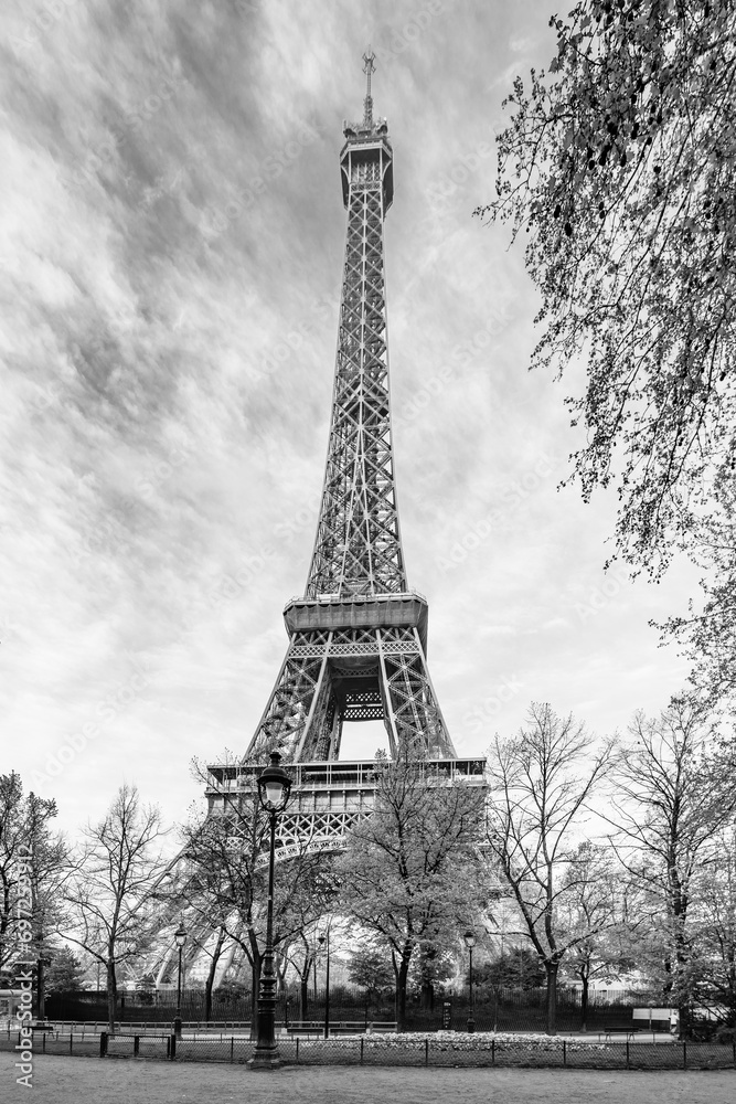 Sunny morning in the park at Eiffel Tower, Paris, France. Black and white photography.