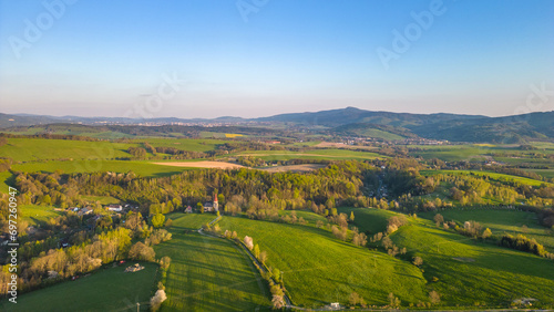 Green rural landscape around Liberec with Jested mountain ridge on background. Sunny summer evening  Czechia