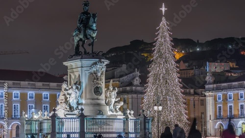 Commerce square illuminated and decorated at Christmas time in Lisbon night timelapse. Commercio square with Christmas tree and Jose I monument. People tourists crowd around. Holiday times. Portugal photo