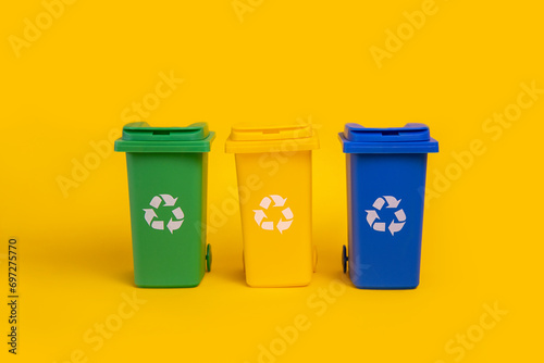 Garbage cans on yellow background