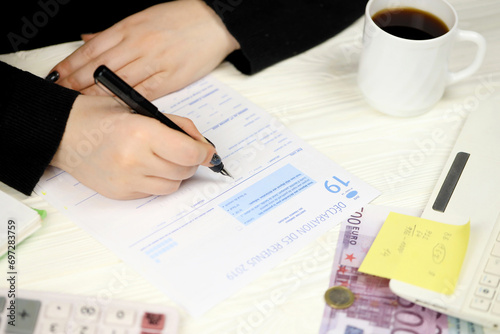 Accountant fill french tax form 2042 income statement in end of tax period. Taxation and paperwork routine in France photo