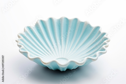a white bowl with a blue shell design