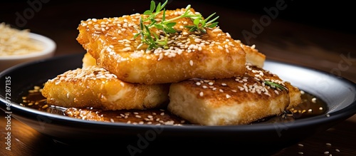 Greek fried cheese, Saganaki or Feta, a delicious starter: crispy with honey and sesame seeds. photo