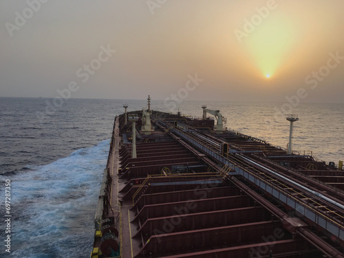 A merchant ship is underway at sea, view from the bridge wings