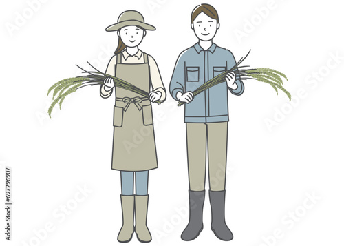 収穫した米を手に持つ若い男性と女性