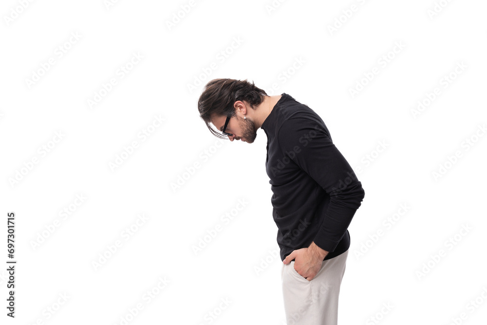 well-groomed young caucasian brunette man with a beard put on glasses for the correction of granulation well-groomed young caucasian brunette man with a beard put on glasses for the correction of granulation