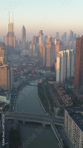 Shanghai Skyline in the Sunny Morning. Puxi District. China. Aerial View. Drone is Flying Forward and Upward. Establishing Shot. Vertical Video photo