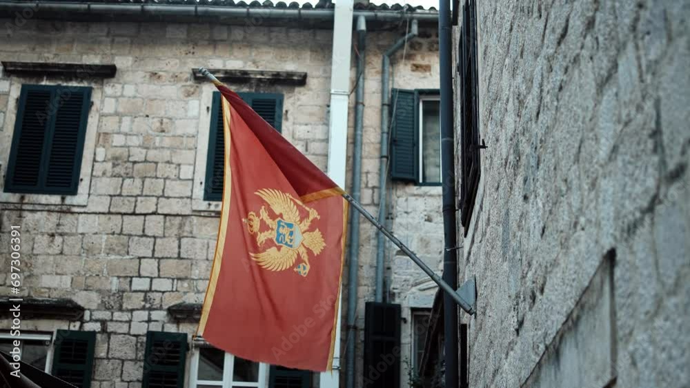 Flag of Montenegro, on the street, in the wind. Montenegro, Adriatic sea