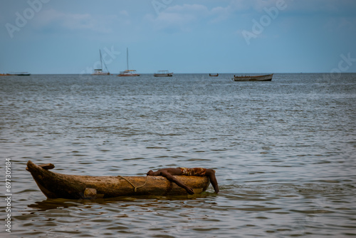 Fishrrman resting on his dugout canoe in Cape Maclear, Malawi photo