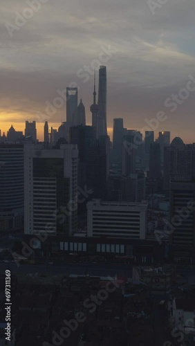 Shanghai Skyline at Sunny Sunrise. Aerial View. China. Drone is Flying Forward and Upward. Establishing Shot. Vertical Video photo