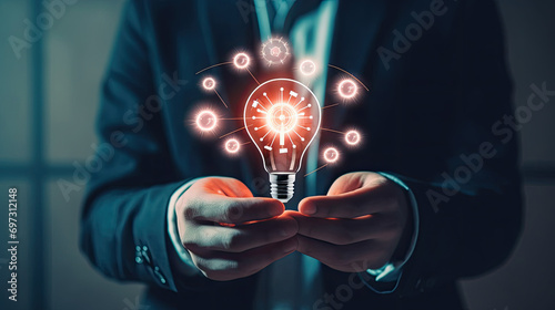 A man in a suit holding a light bulb, features a professional man in a suit holding a glowing light bulb. Suitable for business, innovation, creativity, and leadership concepts. photo