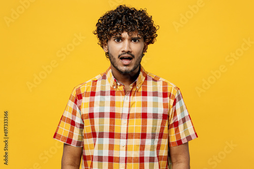 Young shocked mad outraged indignant sad furious astonished offended Indian man he wears shirt casual clothes look camera isolated on plain yellow color background studio portrait. Lifestyle concept. photo