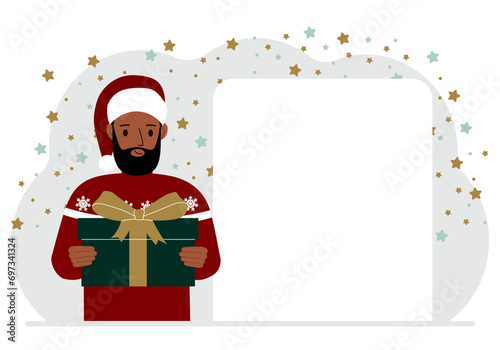 A man in a red sweater is holding a large gift box with a bow. New Year or Christmas.