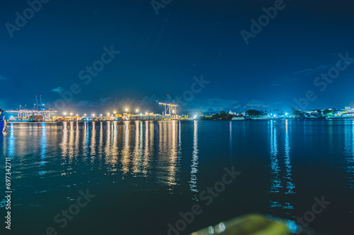 Navegantes Marina, cargo ship moored in Navegantes-SC at night with cranes taking the containers, photo taken from inside the ferry boat