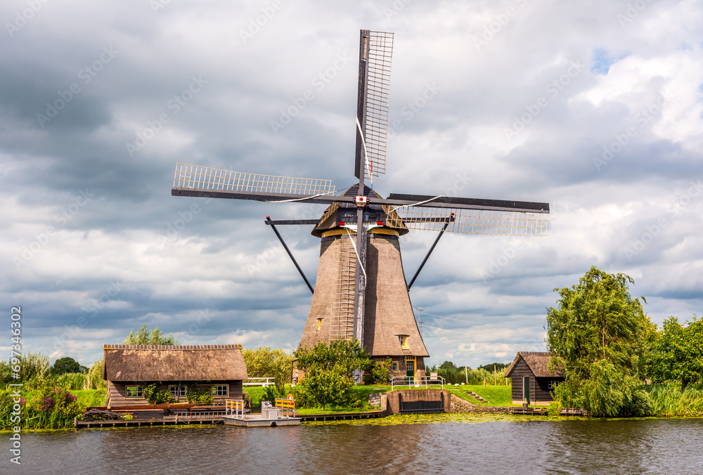 Front view of the Overwaard windmill No. 7, one of the Kinderdijk mills near Rotterdam, Netherlands, built in 1740 to drain the Alblasserwaard polder, under a stormy sky.