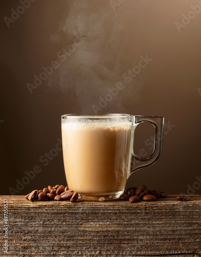 Glass cup of coffee drink, latte or mocha on a brown background.