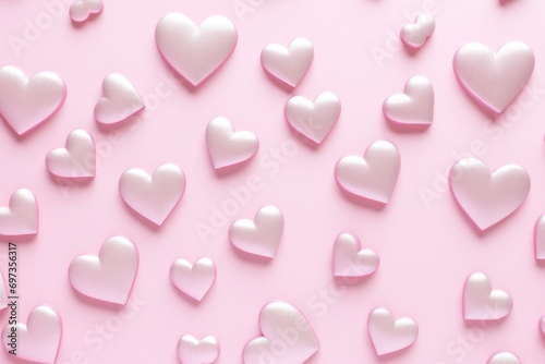 Close-up view of pink heart shapes in different sizes on a soft pink background