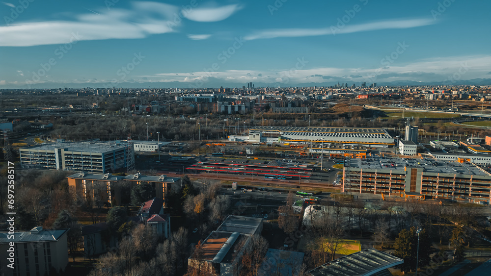 View fashion capital Milan against a blue sky from a drone in December. Drone view of Milan from San Donato Milanese. Metro station San Donato M3 Milano.