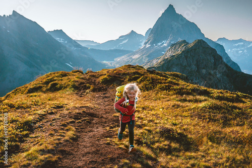 Child girl running in mountains adventure travel family vacations outdoor active healthy lifestyle 4 years old kid with backpack hiking in Norway