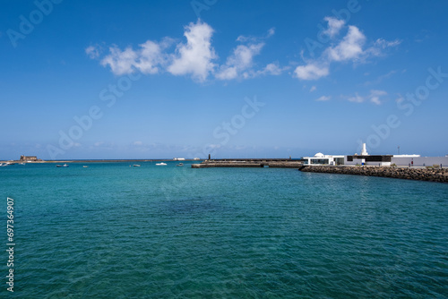 View of the Fermina islet. Turquoise blue water. Sky with big white clouds. Seascape. Lanzarote, Canary Islands, Spain.