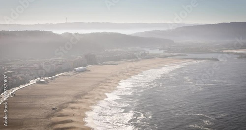 a view over Nazare town and the beach on a foggy winter day, municipality of Alcobaça, district of Leiria, Portugal  photo